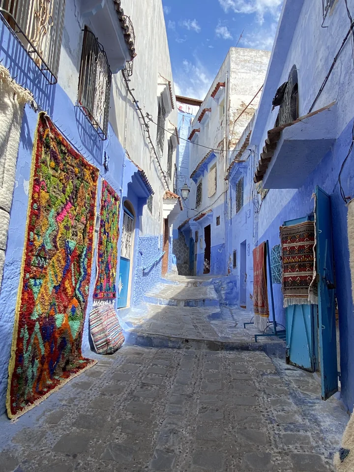 A stone stairway between blue houses in the Chefchaouen medina