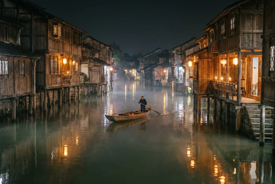 Illuminated stilt houses and a boat on the Tuojiang River at night, Fenghuang, visualization