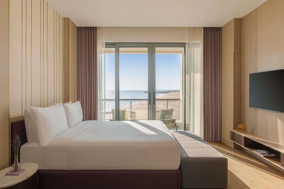 Sea-facing bedroom and balcony of a waterfront chalet at Rixos Premium Qetaifan Island North
