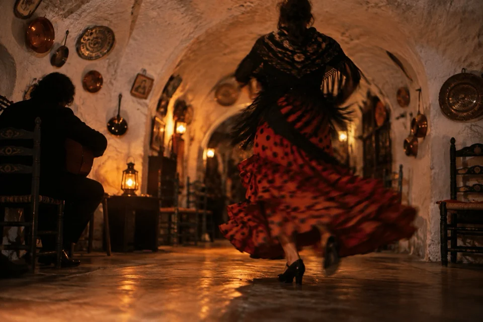 Flamenco by lantern light against the whitewashed walls of a Sacromonte cave in Granada