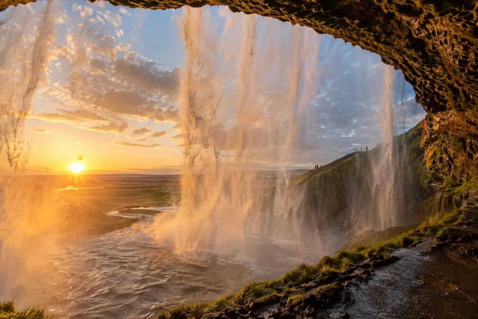 Sunset from the walking path behind the curtain of water at Seljalandsfoss waterfall