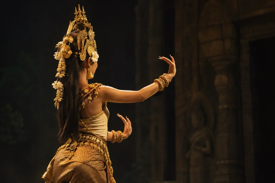 Apsara dancer in a golden headdress on stage in Siem Reap, seen in profile