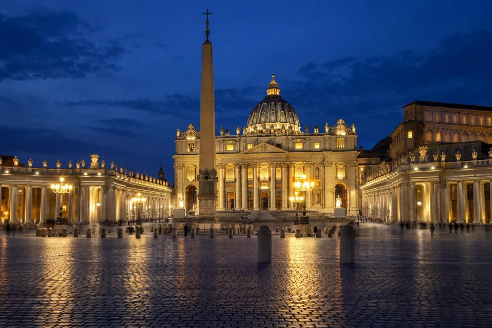 St Peter's Square in the Vatican at night, the basilica dome and colonnades lit