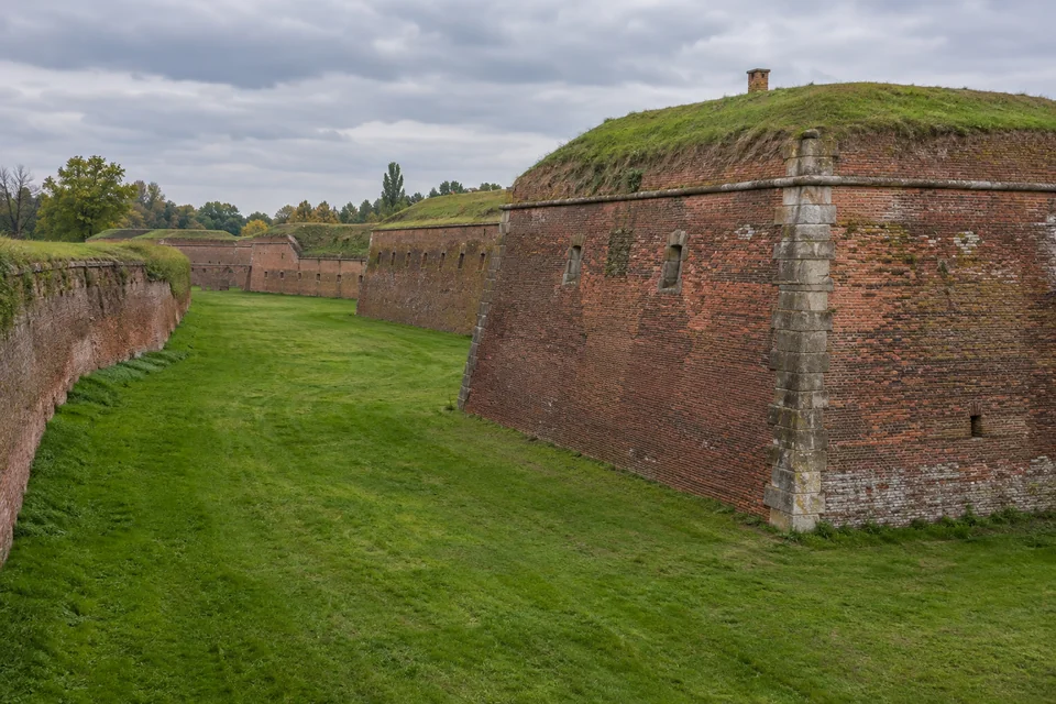The red brick ramparts and grassy moat of the fortress town of Terezin