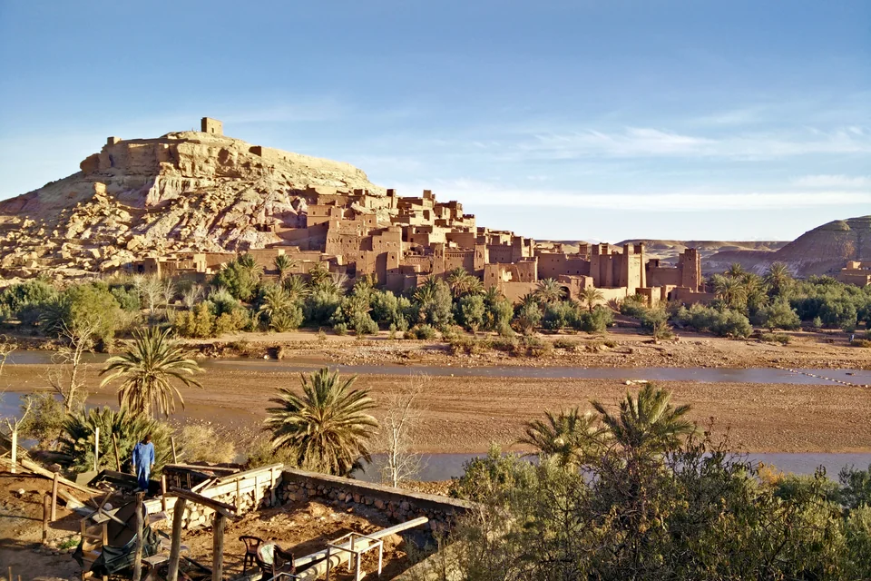 The mud-brick ksar of Ait Benhaddou with riverside palms and the hilltop granary