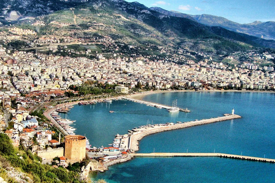 The Red Tower, the harbour, its breakwater and the Taurus Mountains behind, Alanya