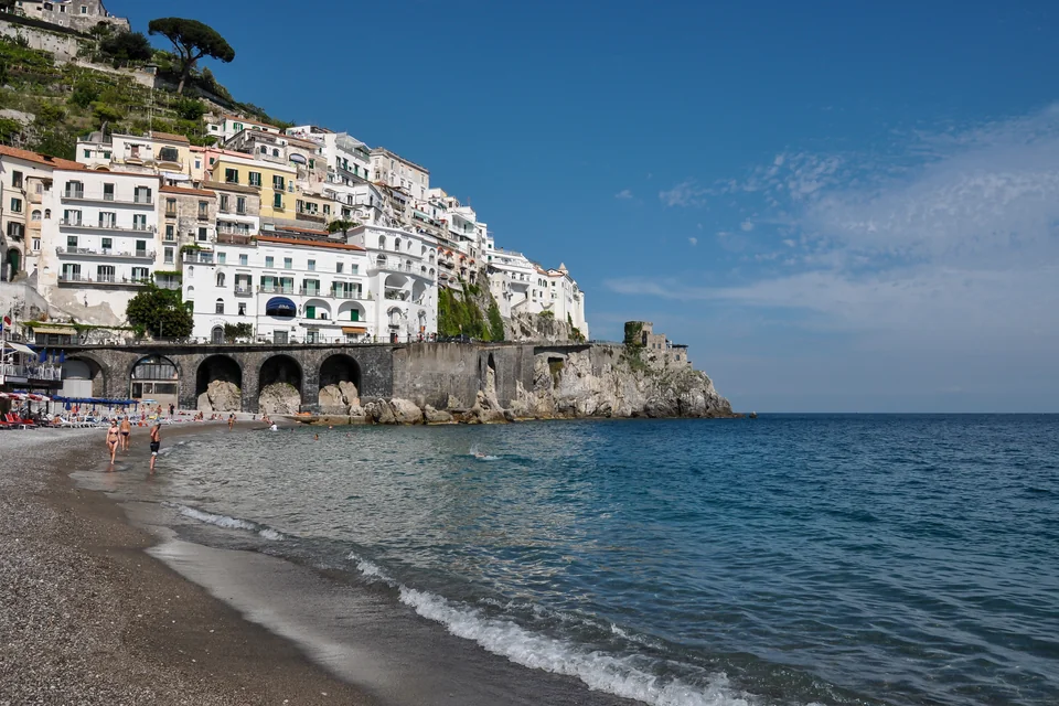 White houses built on the hillside above the beach in Amalfi