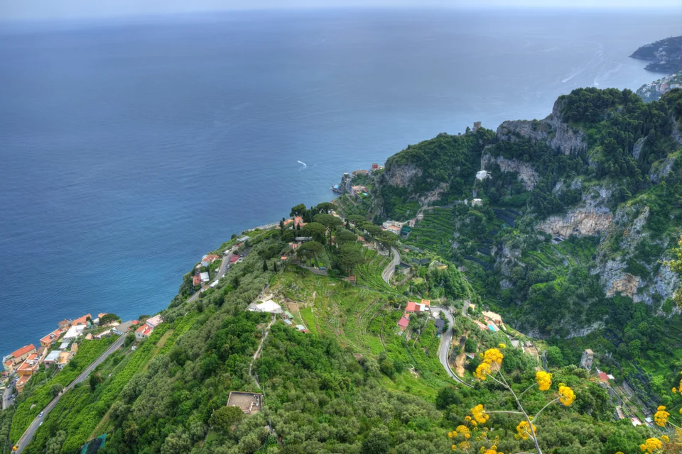 Green slopes falling to the sea and a winding road on the Amalfi Coast