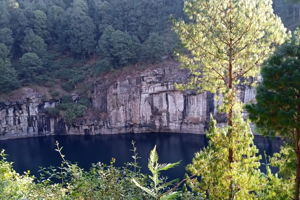 Lake Tritriva and its steep cliffs inside a volcanic crater near Antsirabe