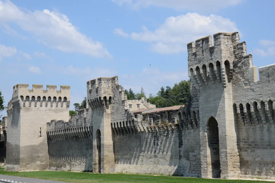 The crenellated medieval city walls and towers of Avignon
