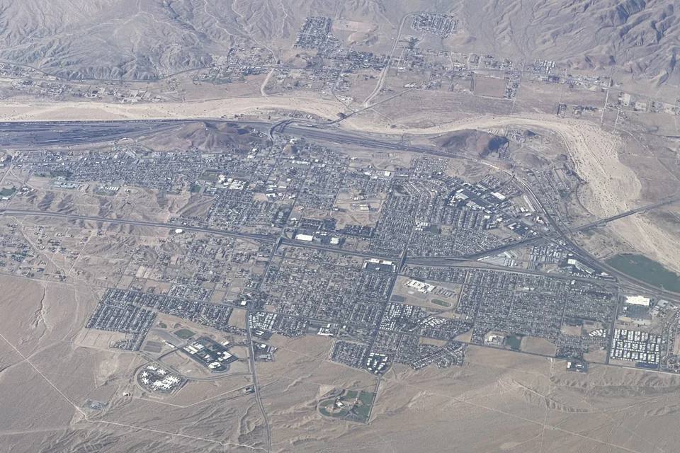 An aerial view of Barstow in its desert valley with the surrounding mountains