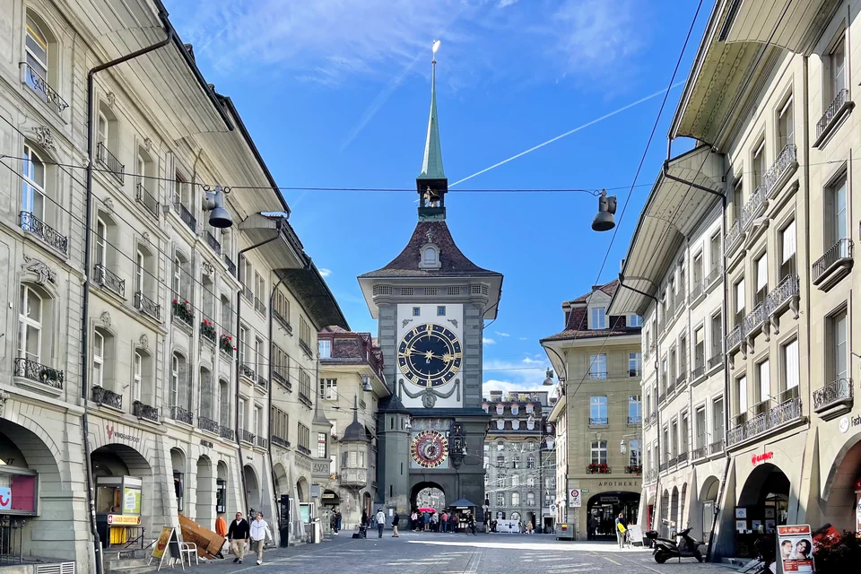 The Zytglogge tower with its astronomical clock at the end of an arcaded street, Bern