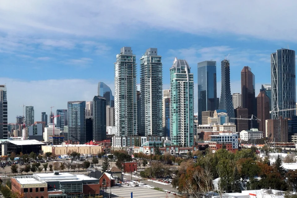 The downtown Calgary skyline of glass towers under a blue sky, Alberta