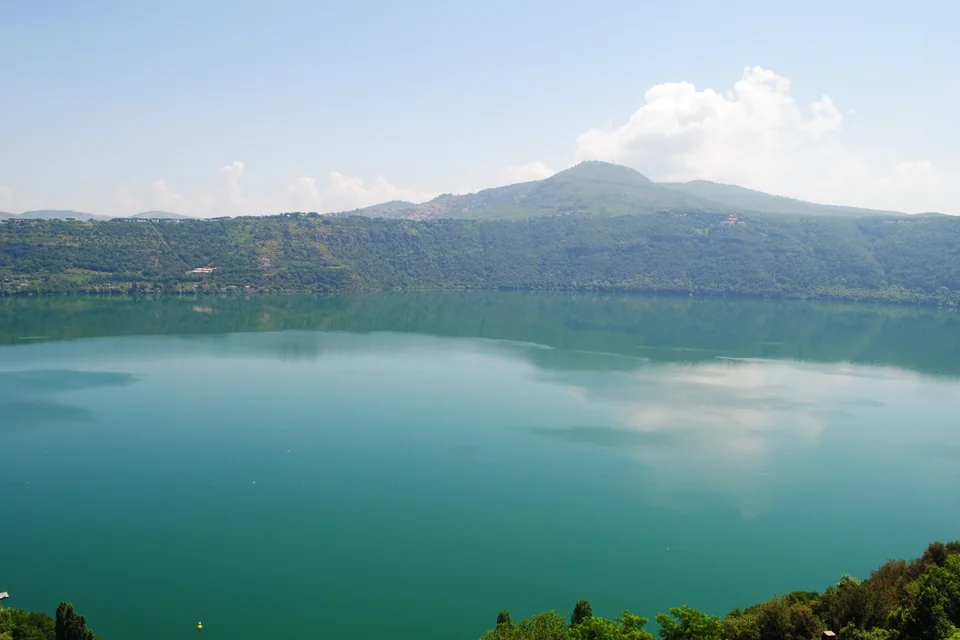 The turquoise crater Lake Albano and its wooded shores at Castel Gandolfo