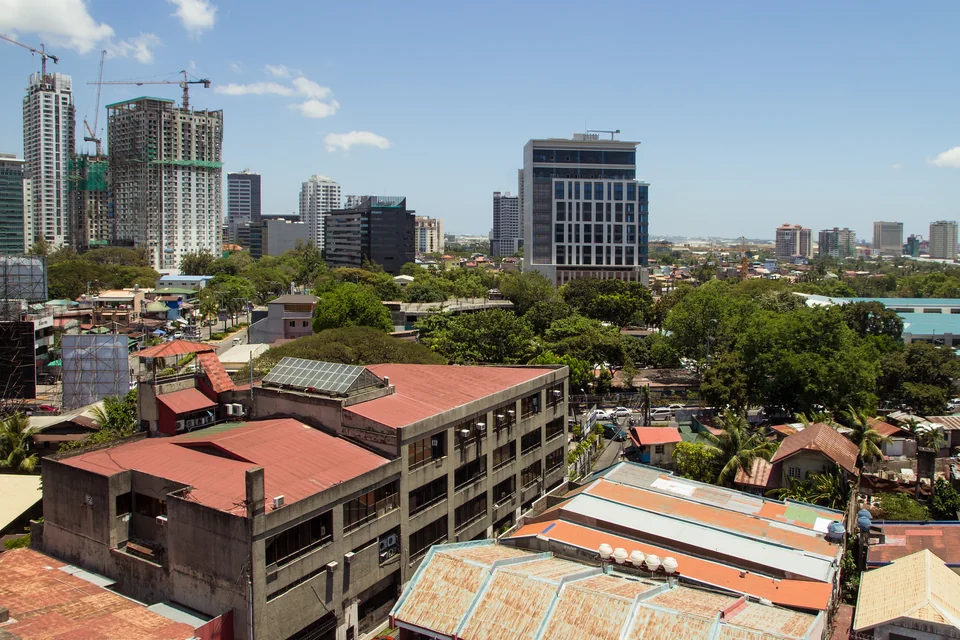 New towers rising beyond red rooftops in Cebu City