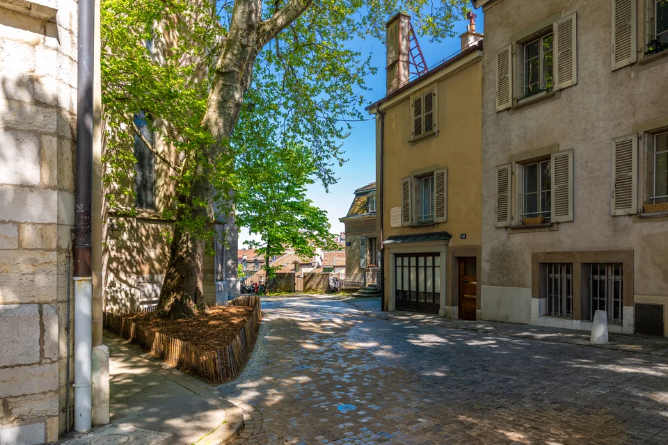 A quiet cobbled lane between historic houses in Geneva's old town