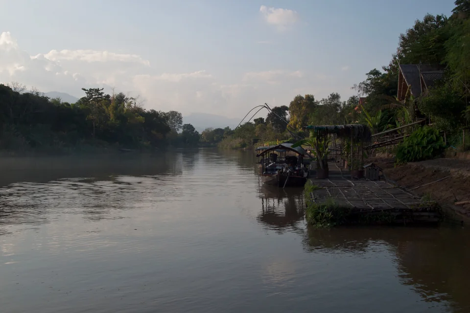 The Ping River, wooded banks and a wooden jetty north of Chiang Mai