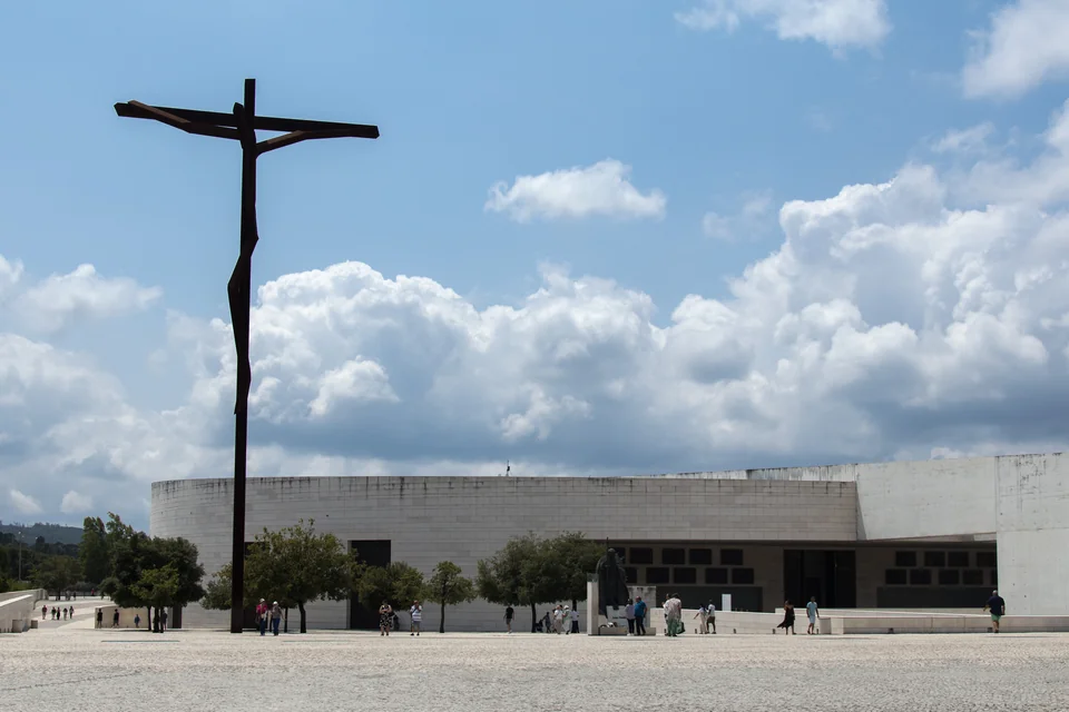 The tall bronze cross in front of the Church of the Holy Trinity in Fátima