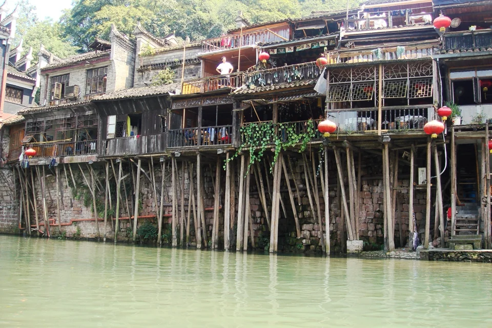 Old timber houses on stilts above the Tuo River in Fenghuang