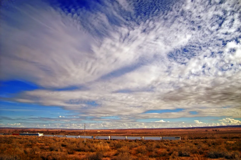 The red desert plain beneath a sky of clouds near Gallup