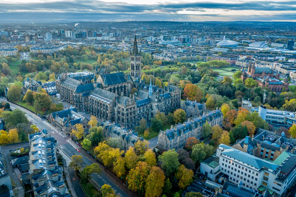 An aerial view of the Gothic tower of the University of Glasgow and autumn Kelvingrove Park