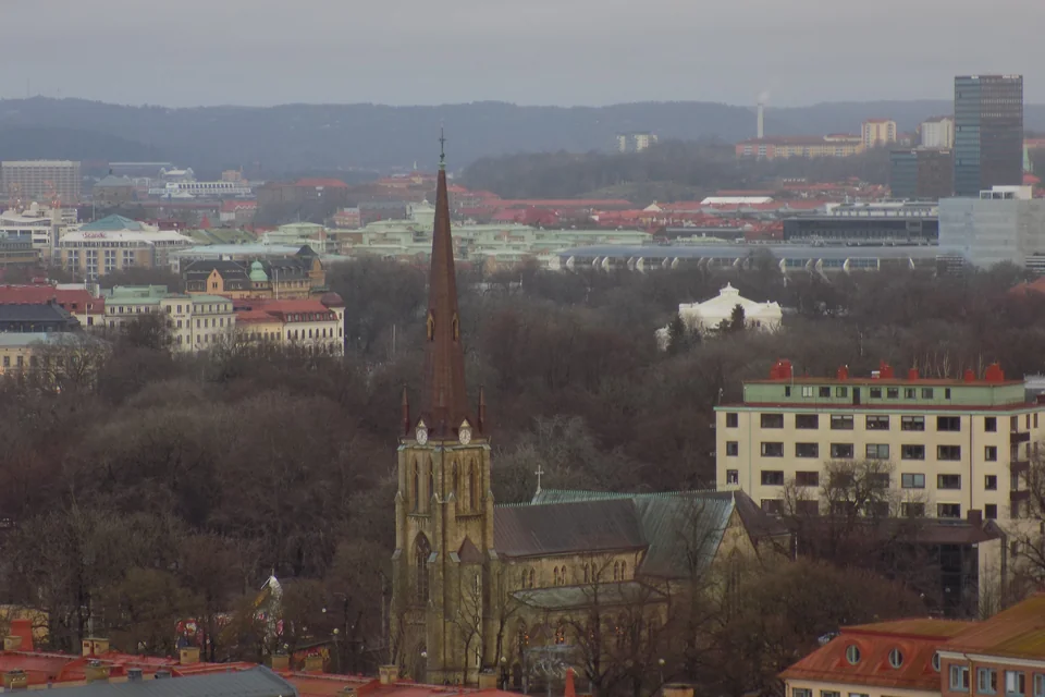 The spire of Haga Church rising among trees and rooftops in Gothenburg