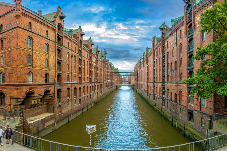 A canal and bridge between the red-brick warehouses of the Speicherstadt, Hamburg
