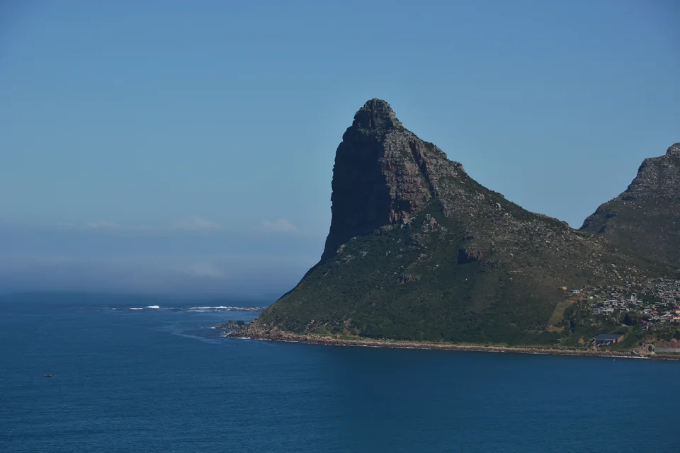 The sheer Sentinel peak rising from the sea at the mouth of Hout Bay