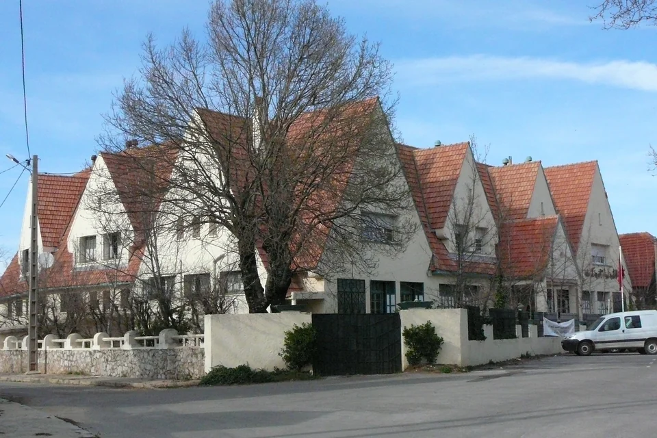 European-style houses with red tiled roofs and bare trees in Ifrane
