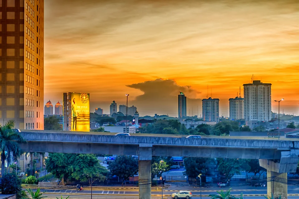 High-rise towers and an elevated road at sunset in Jakarta