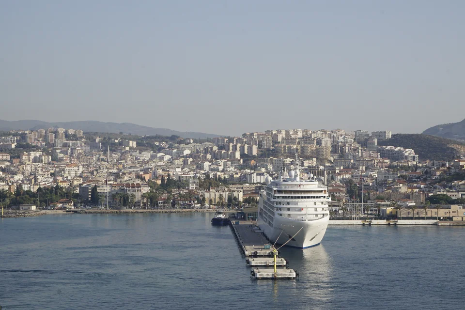 A cruise ship in the harbour and the town spread over the hills, Kuşadası