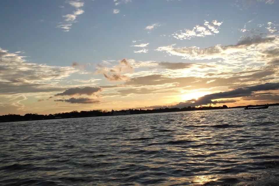 Sunset over the Amazon waters and forested shore at Leticia