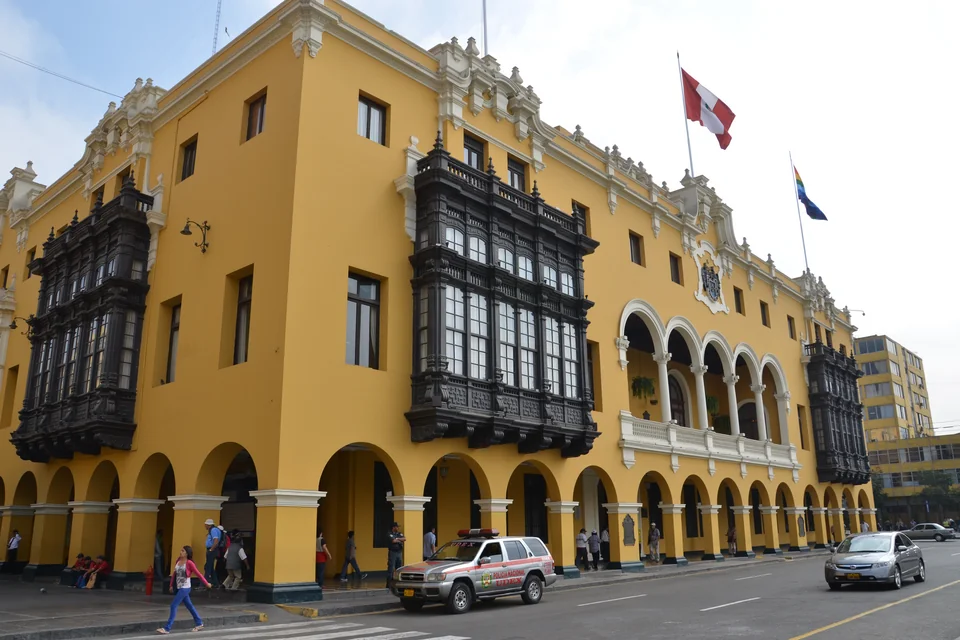 The yellow historic Municipal Palace with carved wooden balconies in Lima
