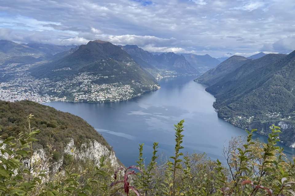 Lake Lugano stretching between mountains with the city on its shore