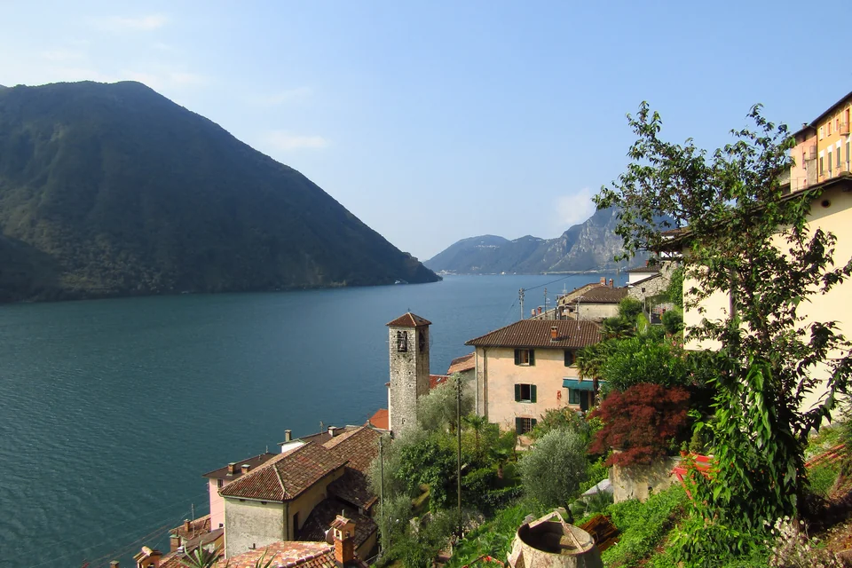 The stone houses and church tower of Gandria village on Lake Lugano