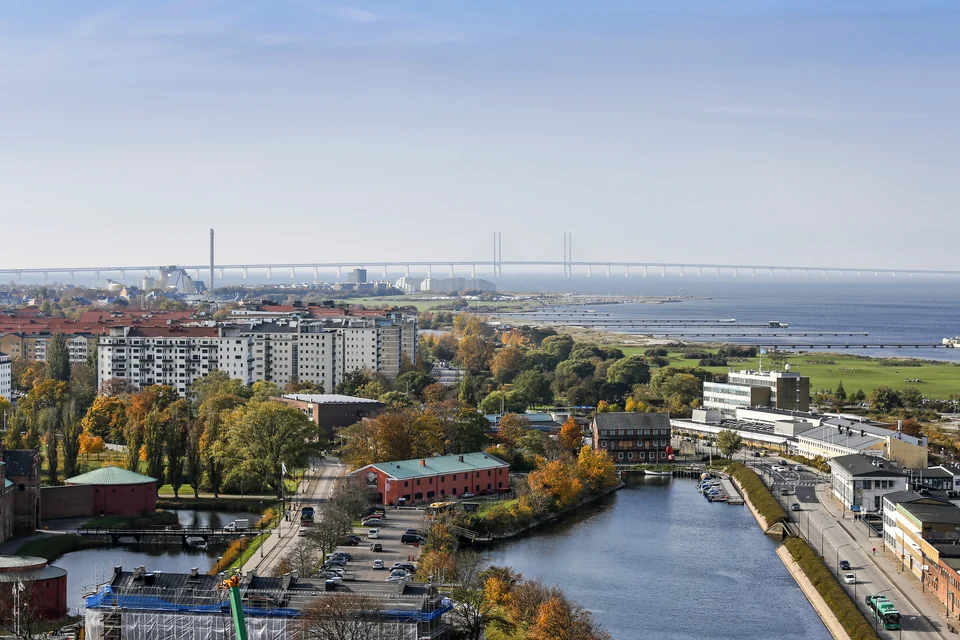 Malmö, a canal and the Öresund Bridge on the horizon seen from above