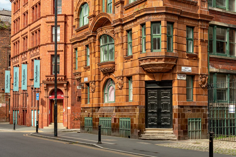 A Victorian building with red brick and terracotta facade in Manchester