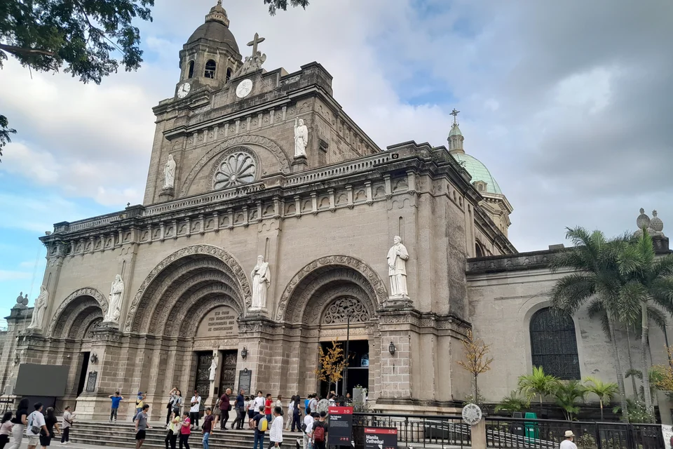 The stone-fronted Manila Cathedral and its bell tower in Intramuros