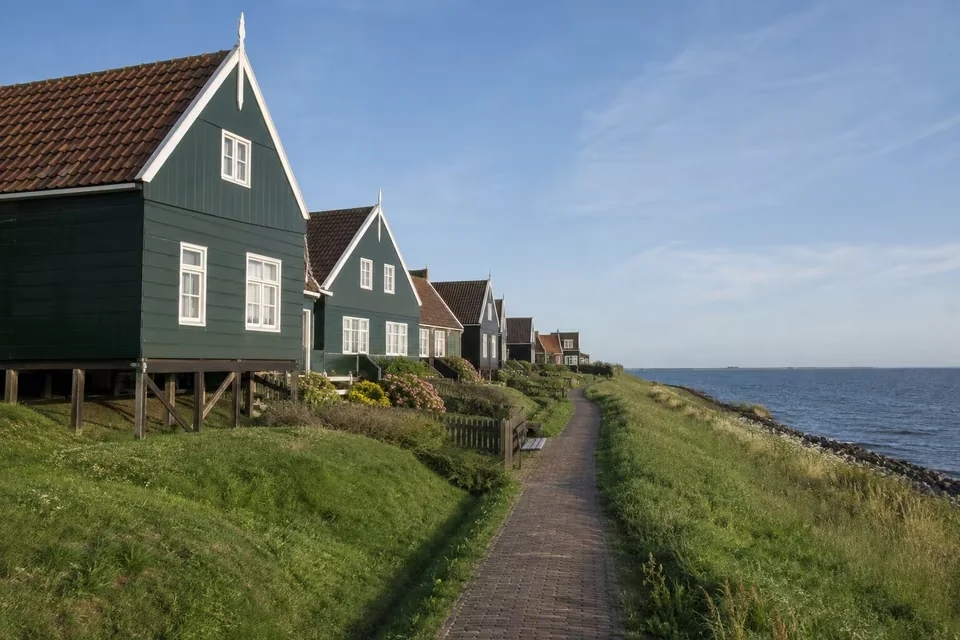 Green wooden houses and the pier at Marken