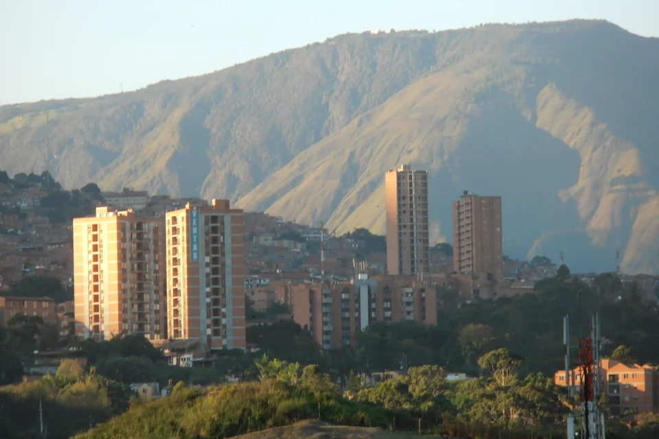 Tower blocks in evening light with the green Andes behind, Medellín
