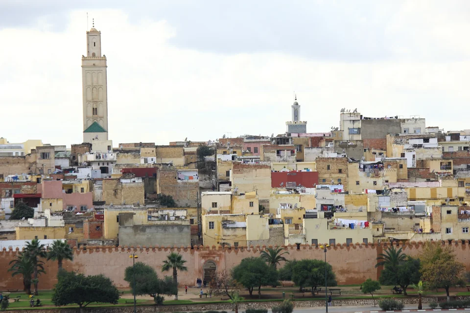 The medina rising above the city walls with tall minarets in Meknes