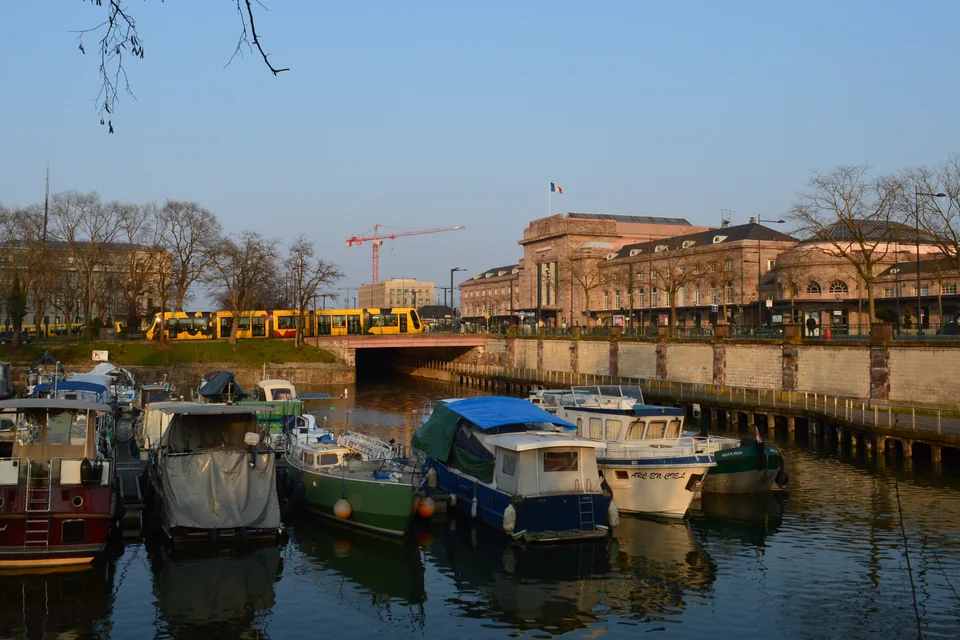 Boats in the canal port with the historic railway station behind, Mulhouse