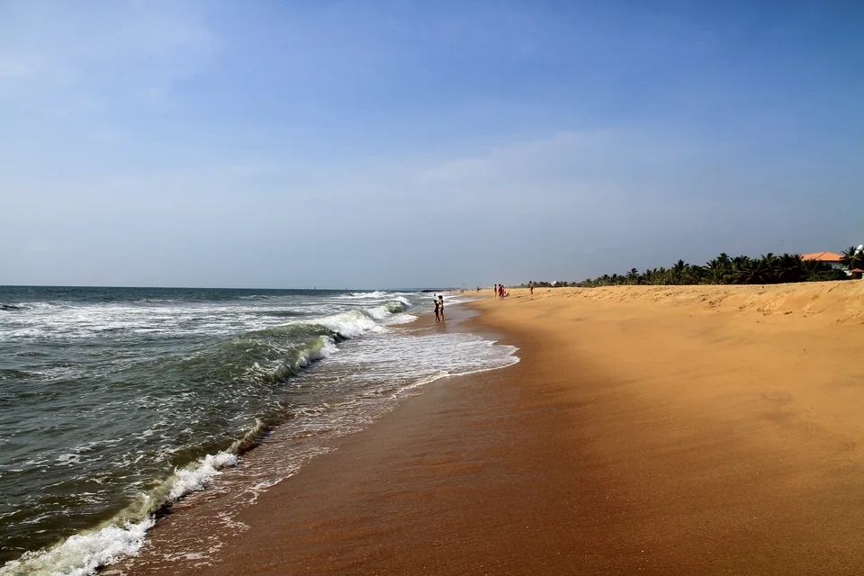 A golden beach stretching along the shore and Indian Ocean waves at Negombo