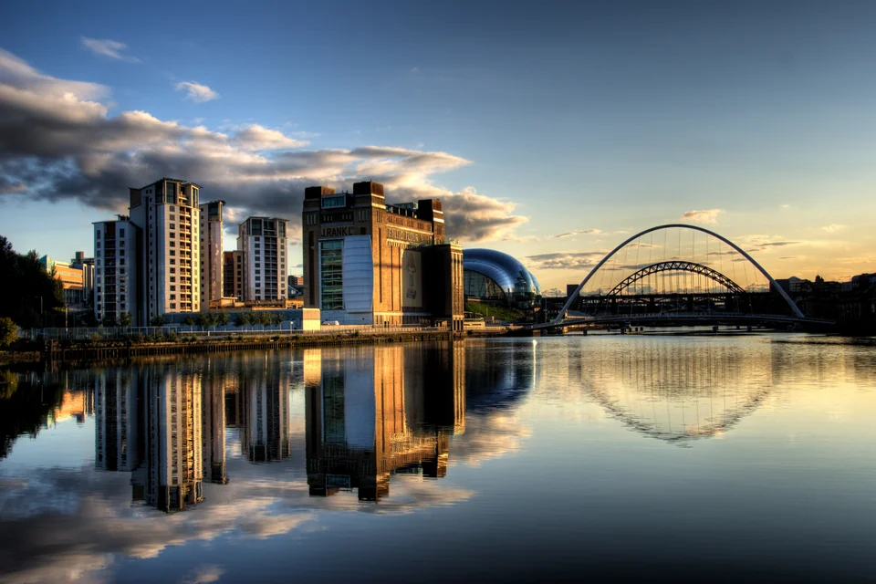 The Millennium Bridge and quayside buildings reflected in the River Tyne, Newcastle