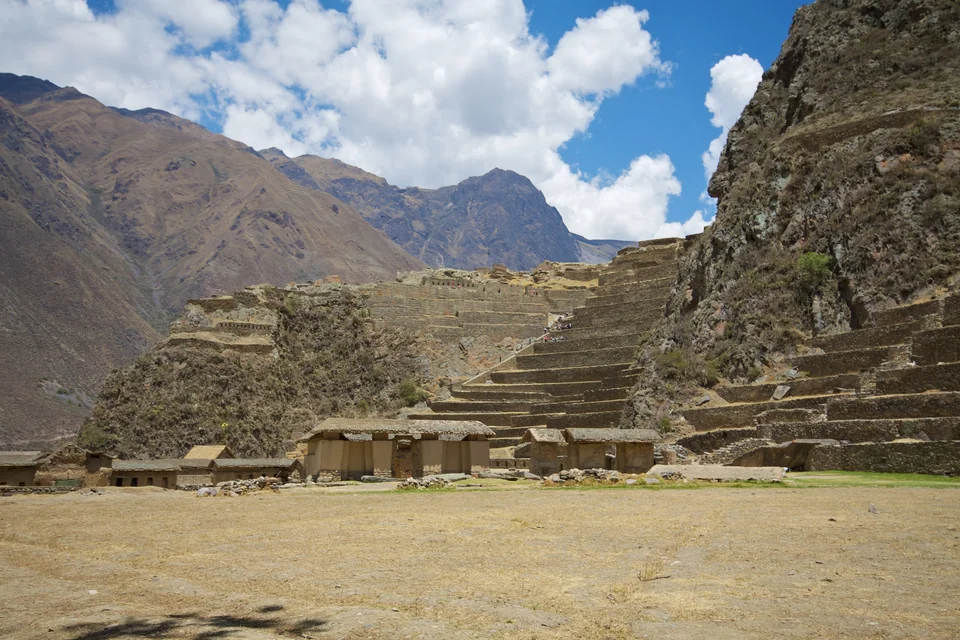 Inca terraces climbing the steep mountainside above the valley at Ollantaytambo