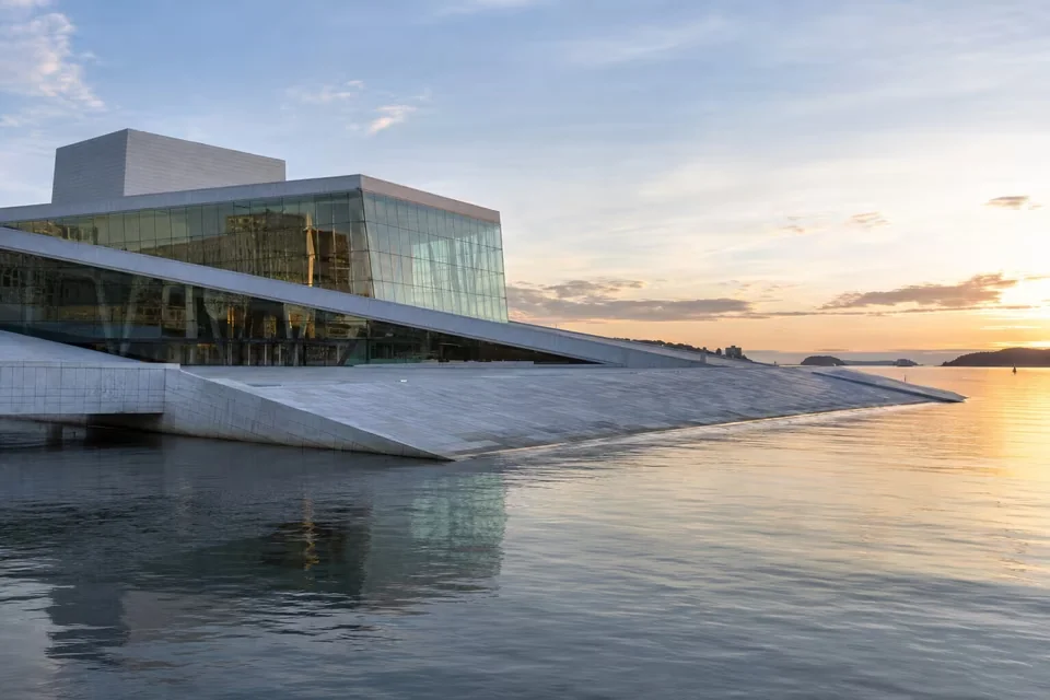 The sloping roof of the Oslo Opera House running down into the water