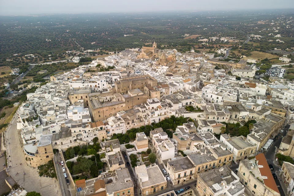 The white hilltop town of Ostuni and its cathedral seen from the air
