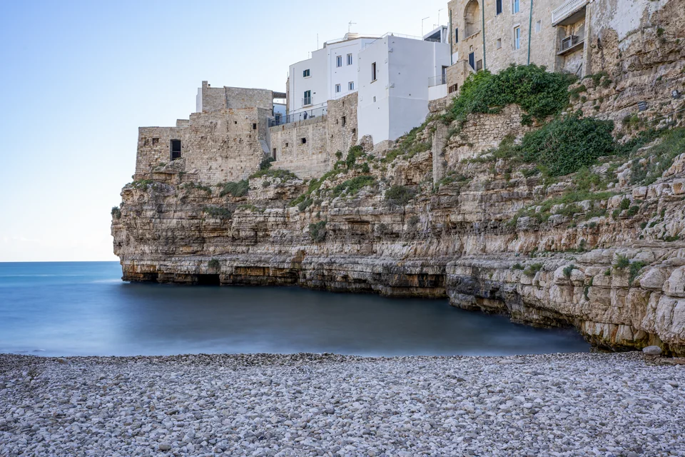 The Lama Monachile cove, its pebble beach and clifftop houses in Polignano a Mare