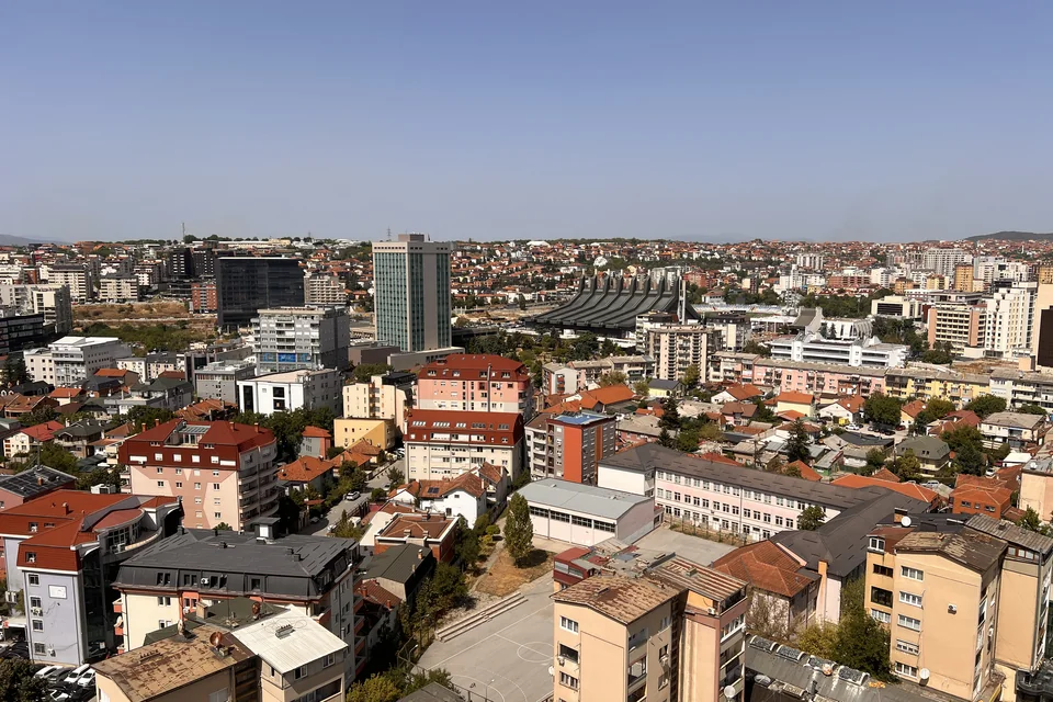 Red rooftops and the city centre of Pristina seen from above