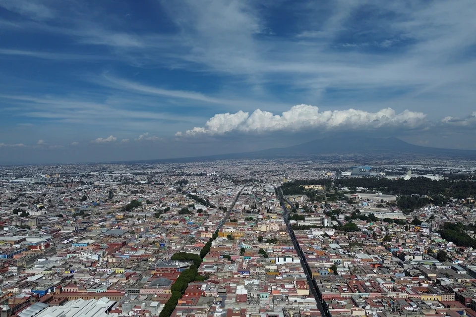 The city of Puebla seen from the air with La Malinche volcano on the horizon